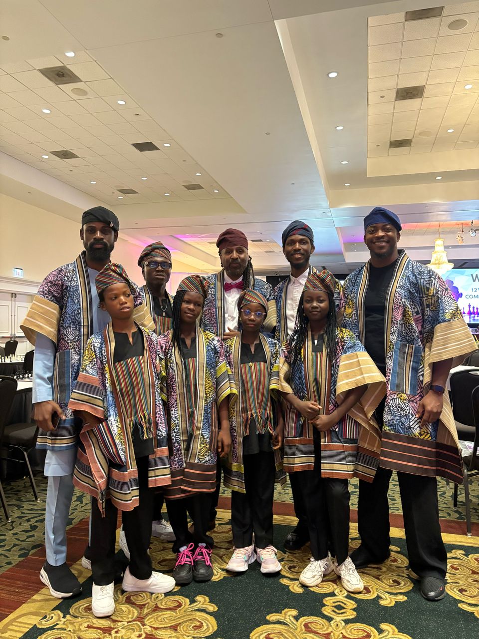 Toluwalase Eniola with a cultural delegation in traditional West African attire