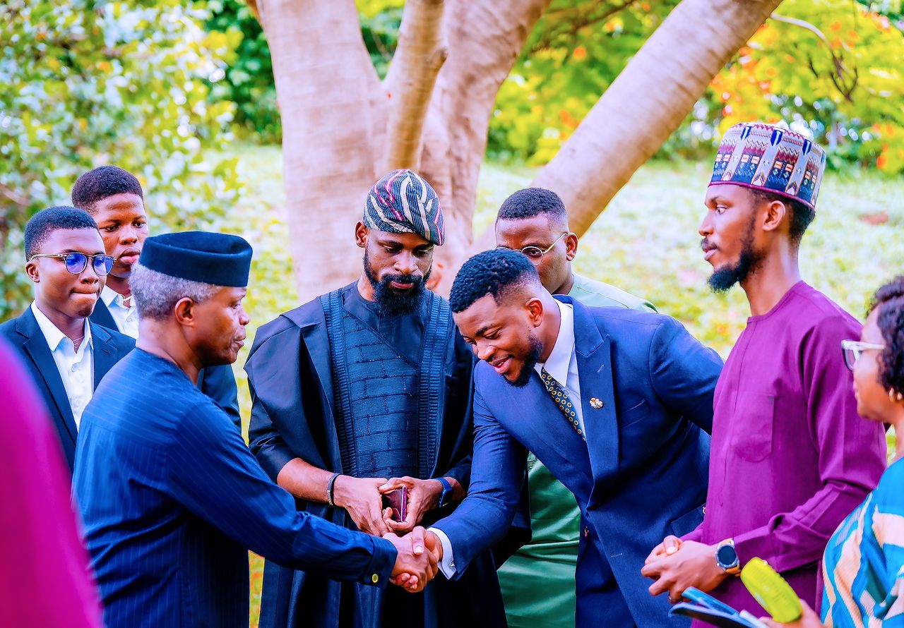 Toluwalase Eniola greeting a leader at an outdoor engagement